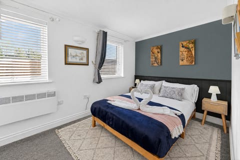 The bedroom features a comfortable double bed with fresh linen and towels provided.