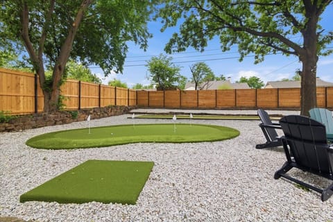 Backyard putting green, bocce court and firepit area.