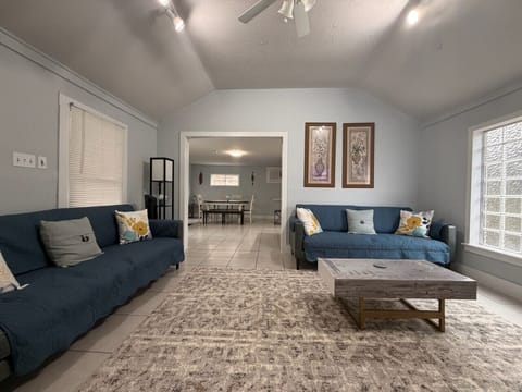 Open-concept living area with vaulted ceilings, comfortable seating, and plenty of natural light—ideal for group conversations or unwinding in comfort.