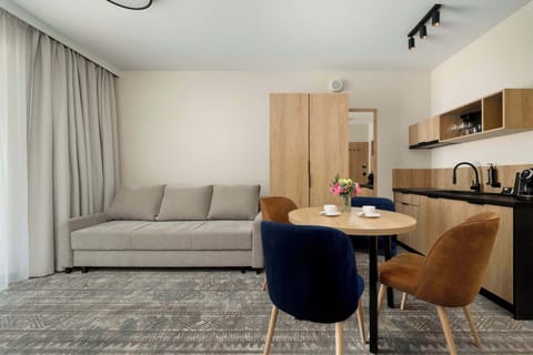 A bright and cozy living room with a comfortable sofa bed and a Smart TV. It is an inviting space perfect for relaxing and spending time together.