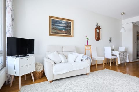 Stay connected and entertained with the flat-screen TV and high-speed Wi-Fi throughout the apartment. The living area is designed for comfort, offering a cozy spot to relax after a day of travel.
