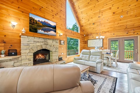 Open-concept living and dining area featuring a 75-inch smart TV