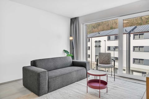 Living room with balcony access, ideal for relaxing and enjoying fresh air.