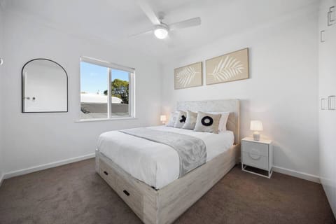 Wake refreshed in the bedroom, where a queen bed and soft neutral tones create a calm, restful retreat.