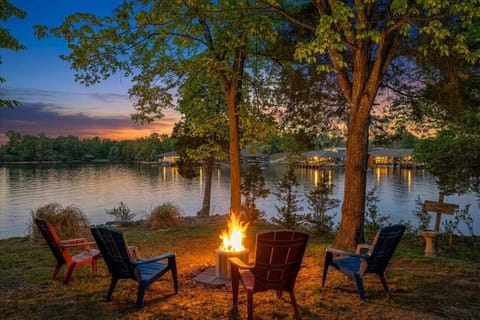 Unwind by the fire as the sun sets over the water