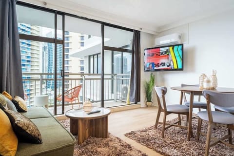 Relax in an Airy Living Space – The open-plan living area offers the perfect spot to unwind with a flat-screen TV and vibrant decor.