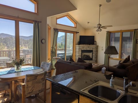 Large mountain view off of living room to deck with Hot Tub and grill.