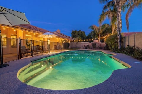 Heated outdoor pool fully fenced with a pool gate for kids' safety purposes.
