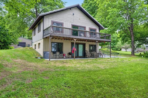A brown cabin, two story with a walk out lower level.