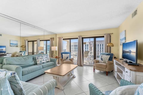 Bright & airy living room with sliding glass doors that lead to an outdoor private patio