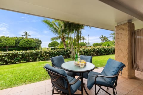 Enjoy al fresco meals on the shaded patio overlooking a beautifully maintained garden and lawn.