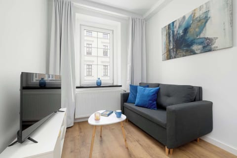 Relax in the stylish living room with a comfortable sofa and modern decor.
