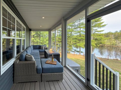 Screened patio with speakers and river views.