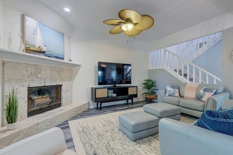 Modern living room with stone fireplace and coastal-inspired decor.