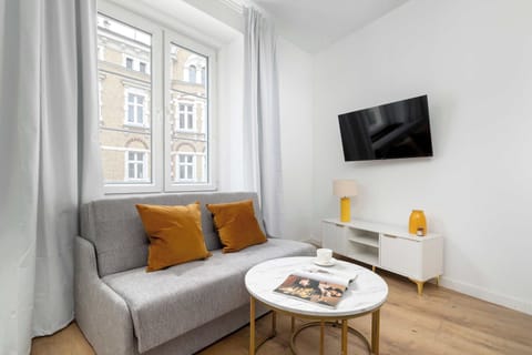 Relax in the stylish living room with a comfortable sofa and modern decor.