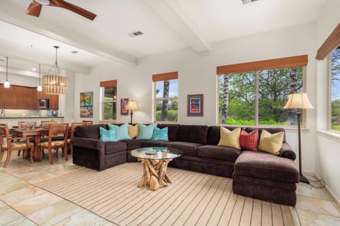 Sink into this plush sectional sofa where colorful pillows invite you to relax while natural light streams through expansive windows.