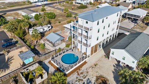 Modern beachside rental features private pool and spacious design in coastal community setting.