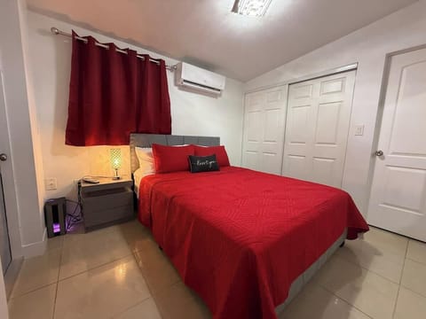 Cozy queen bedroom with smart TV and AC for a comfortable, restful stay.