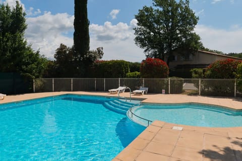 Enjoy a leisurely swim while surrounded by beautiful landscaping and blue skies.