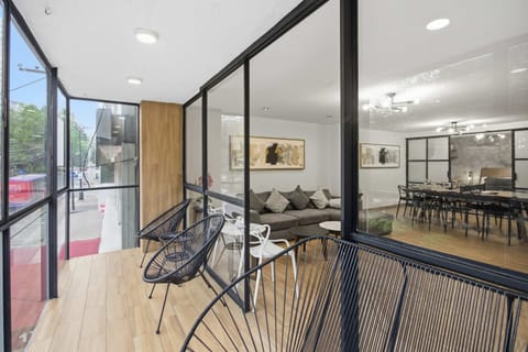 Bright loft-style living area with balcony and Acapulco style seats