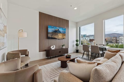 Bright living room area with floor to ceiling windows and natural light, perfect for lounging, meals, and enjoying city views