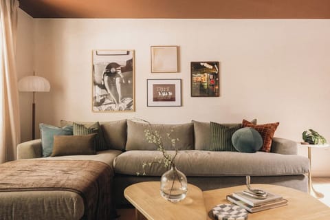 The Lounge - Cozy Japandi-style living room with plush seating, layered textures, and curated wall art.