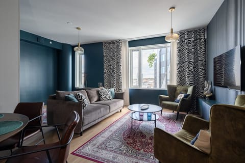 Enjoy movies on the 50-inch Smart TV while relaxing on the high-quality sofa in this stylishly decorated living area. The large windows provide plenty of natural light and a modern urban feel to your stay.