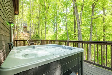 Soak in your private hot tub surrounded by lush forest, where towering trees create a tranquil canopy for ultimate relaxation.