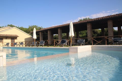 Seasonal outdoor pool, open 9:00 AM to 7:00 PM, pool umbrellas