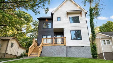 Pull up to this grand, brand new estate with exterior lighting.