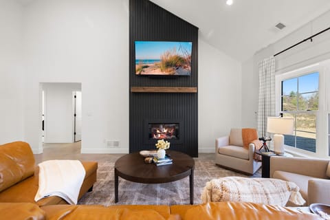Lounge by the fire and enjoy a warm relaxing evening in the living room.