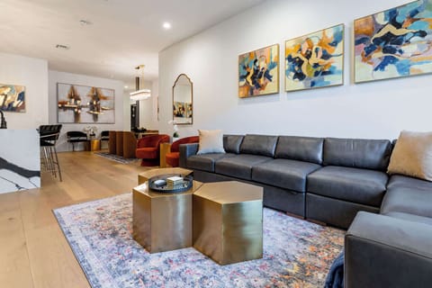 Living, dining, and kitchen area. Fully stocked kitchen. Table seating for six, counter seating for four, queen-size sleeper sofa. Enter suite directly from sidewalk.