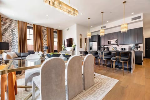 Living, dining, and kitchen area. Fully stocked kitchen. Table seating for six, counter seating for four, queen-size sleeper sofa.