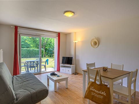 Sliding glass doors open the living and dining area onto a private terrace — step outside after a meal to catch the evening air