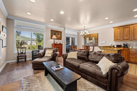 Bright open-concept living area with comfortable seating and seamless flow into the kitchen and dining spaces.