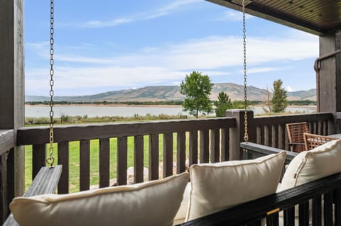 Covered balcony with comfortable seating and beautiful views of Pineview Reservoir and the surrounding mountains.