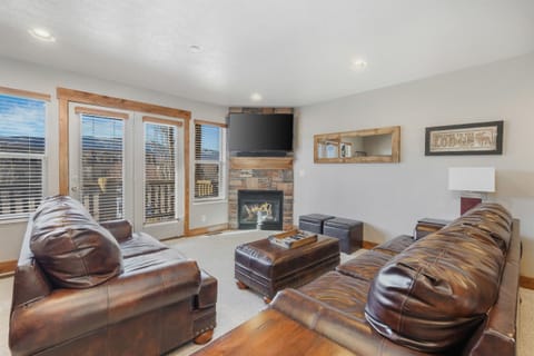 Cozy up in the inviting living room with plush seating and mountain views—perfect for relaxing after a day of adventure.