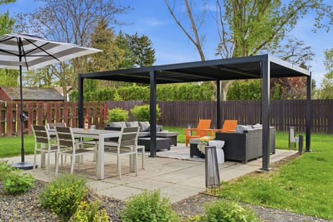 Patio area w/ dining table. covered lounge area.