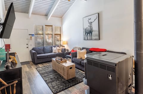 Open living room w/ vaulted ceilings.