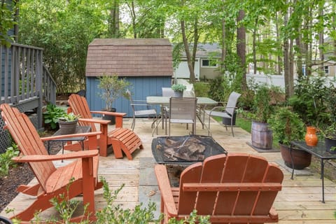 Enjoy the outdoor seating area and firepit surrounded by greenery.