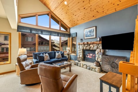 Bright open living room with fireplace and TV