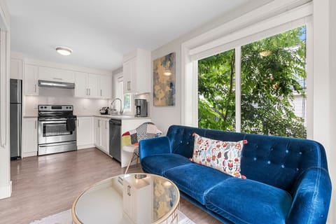 Kitchen & Living Area: Stylish space with a vibrant sofa and sunny views for delightful gatherings!