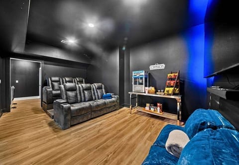This entertainment space is designed for immersive movie nights, complete with comfortable seating and dramatic lighting.