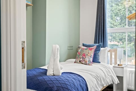 Bright and comfortable bedroom with fresh linens provided