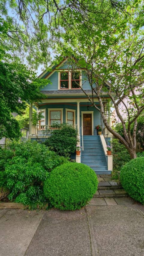 Charming Exterior: Enchanting porch and lush gardens, awaiting your Vancouver adventure!