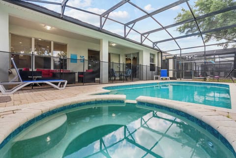 Relax by the screened pool and spa area with comfortable outdoor seating.
