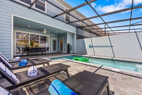 Kick back at your private screened pool-sleek loungers, playful floats, and a shaded patio with dining for 8 create effortless, modern coastal vibes.