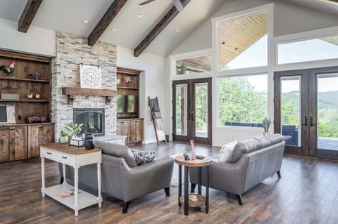 The main living room is perfect for family time, gathering around the fireplace, or taking in the incredible mountain views impeccable framed in the floor-to-ceiling windows.