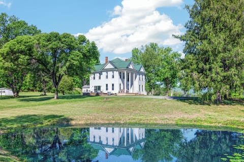 Grand historic home surrounded by peaceful scenery.