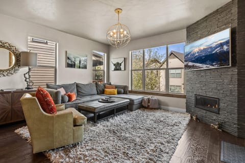 Sink into plush seating by your cozy fireplace while mountain views frame your relaxation through expansive windows.